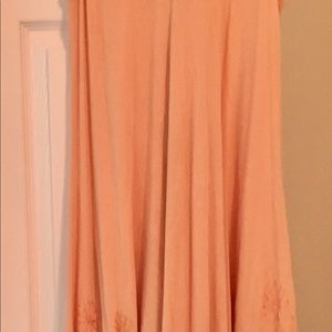 Flowing Peach dress with floral designs.